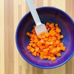 Freshly chopped carrots on a cutting board, ready for a nutritious mea